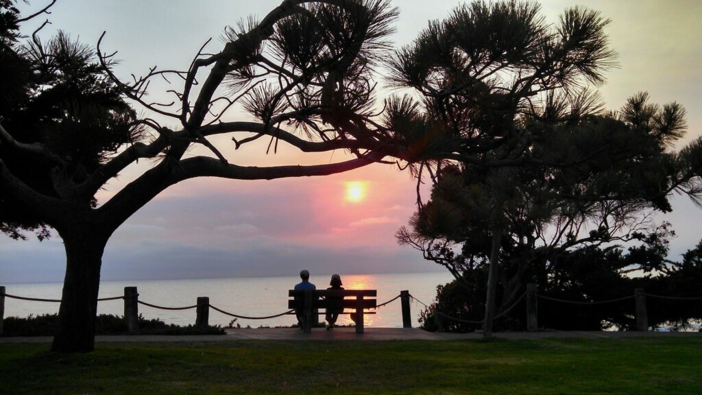 Elderly couple watching sunset
